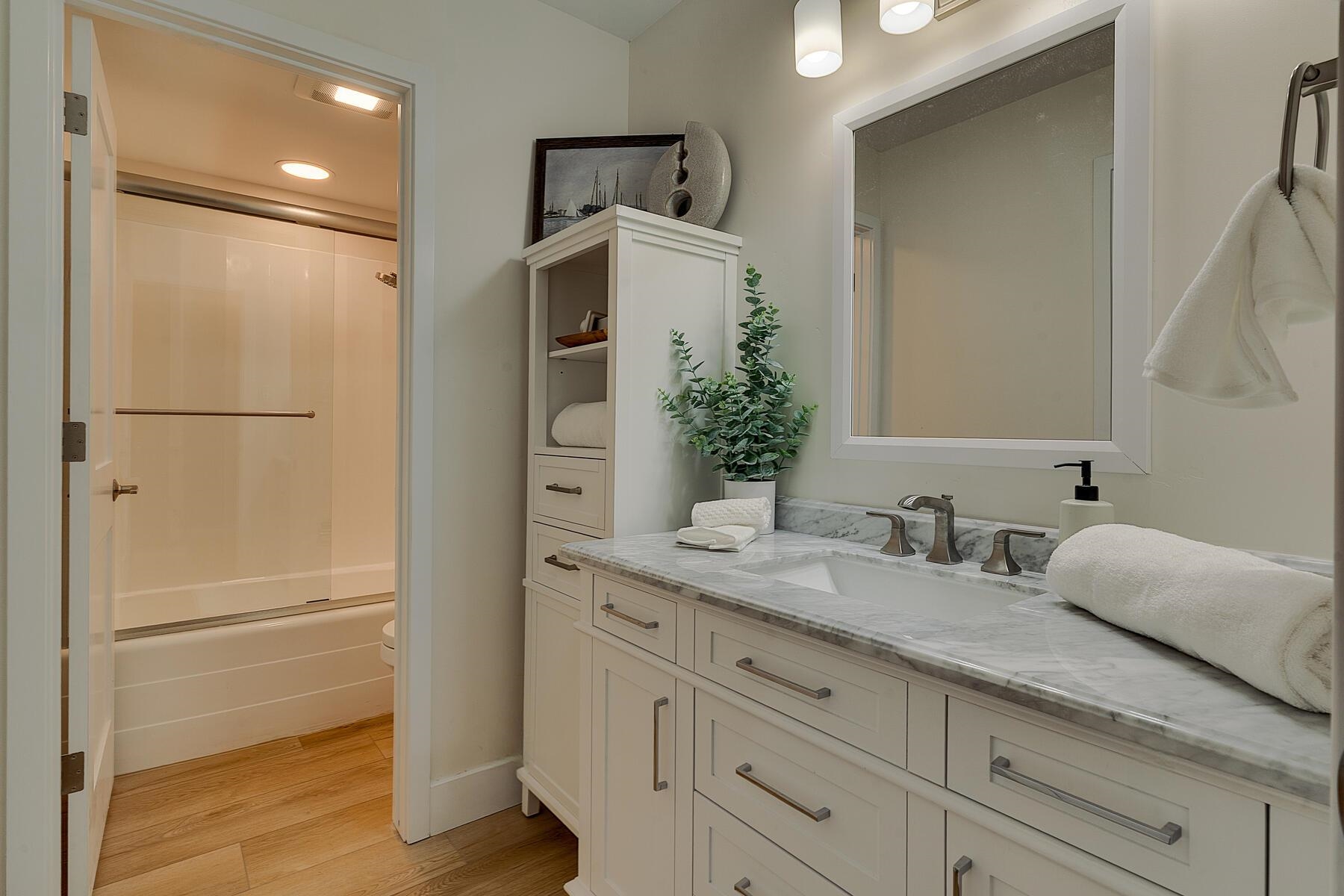 205 Alpine Meadows Road, Unit 2 Alpine Meadows, CA 96145 - Photo 14 of 28 a bathroom with a granite countertop sink and a mirror