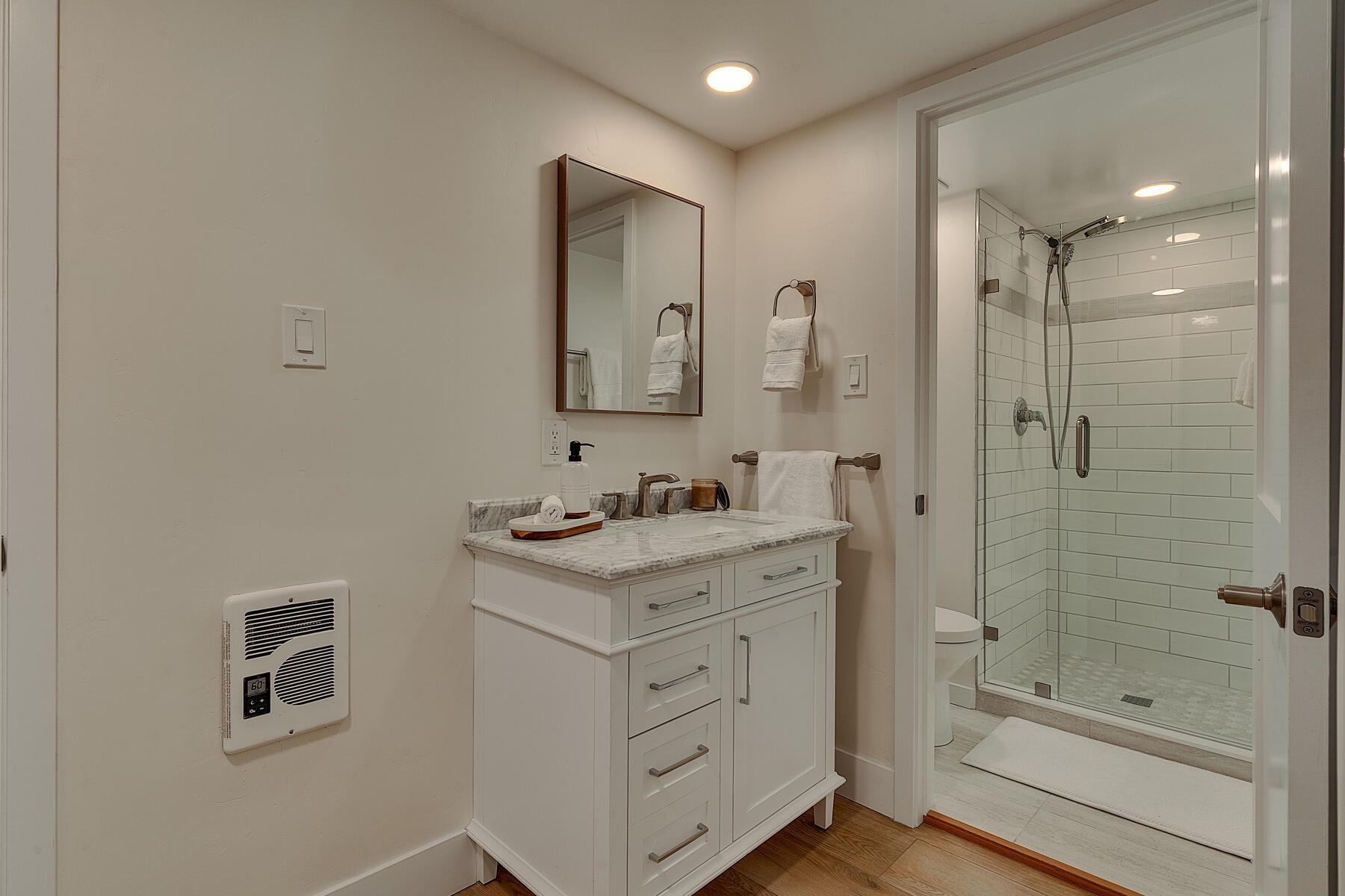 205 Alpine Meadows Road, Unit 2 Alpine Meadows, CA 96145 - Photo 16 of 28 a bathroom with a shower sink vanity and mirror