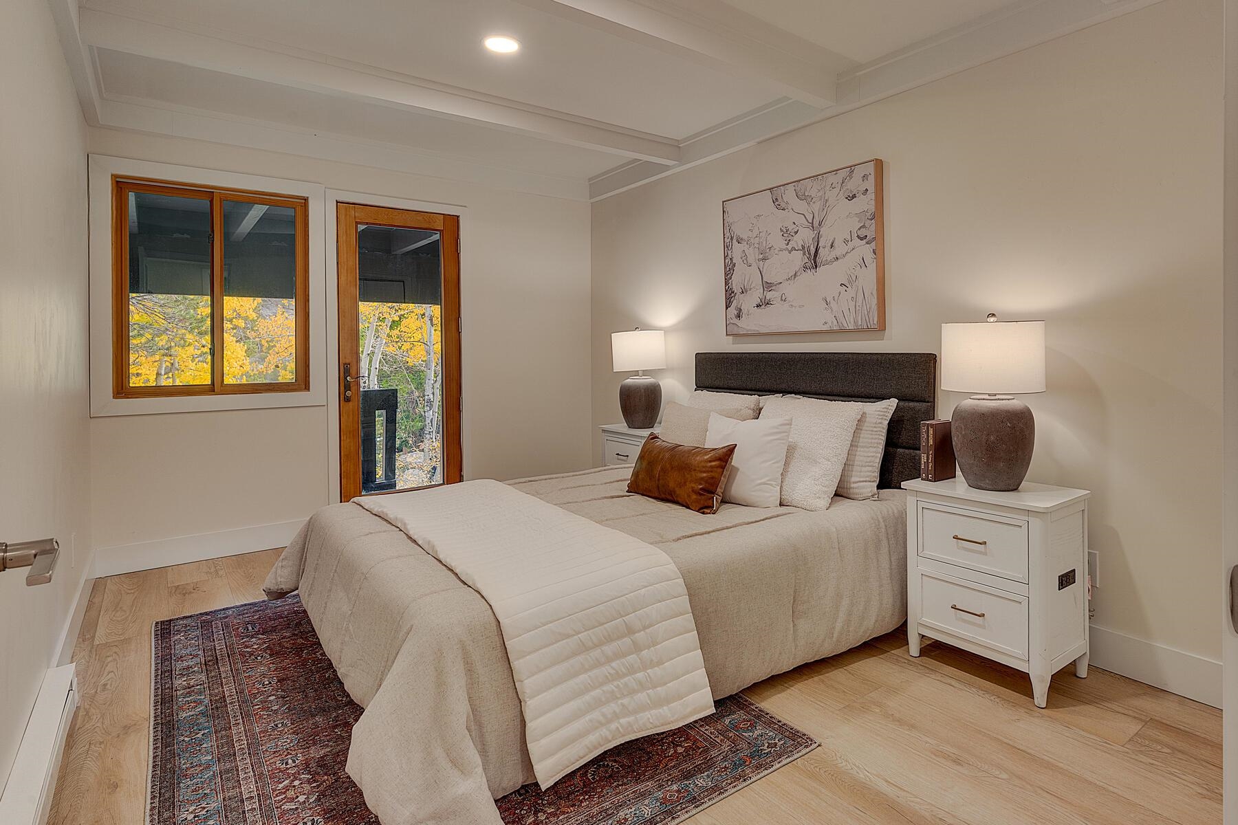 205 Alpine Meadows Road, Unit 2 Alpine Meadows, CA 96145 - Photo 17 of 28 a bedroom with a bed and a painting on the wall