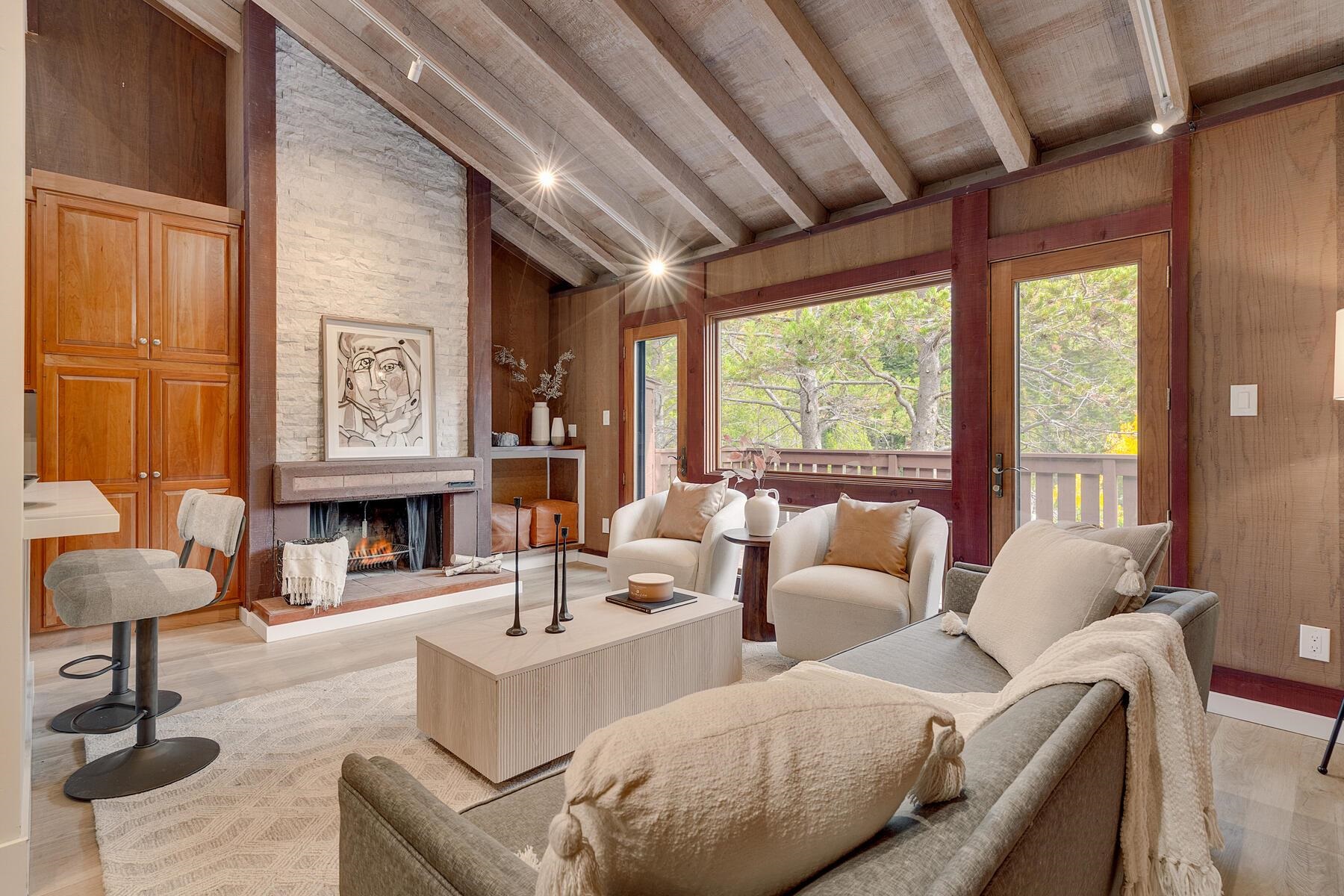 205 Alpine Meadows Road, Unit 2 Alpine Meadows, CA 96145 - Photo 4 of 28 a living room with furniture a fireplace and a large window