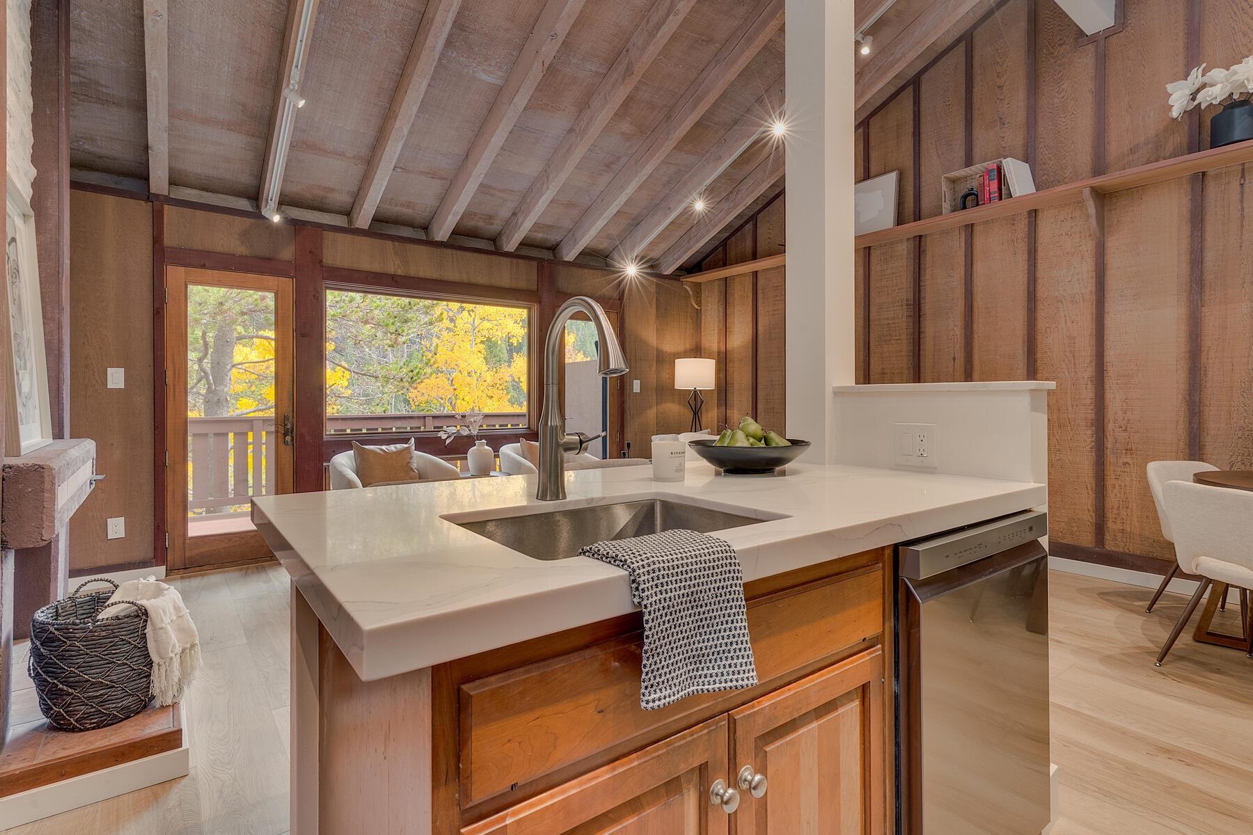 205 Alpine Meadows Road, Unit 2 Alpine Meadows, CA 96145 - Photo 9 of 28 a kitchen with a sink a stove and chairs