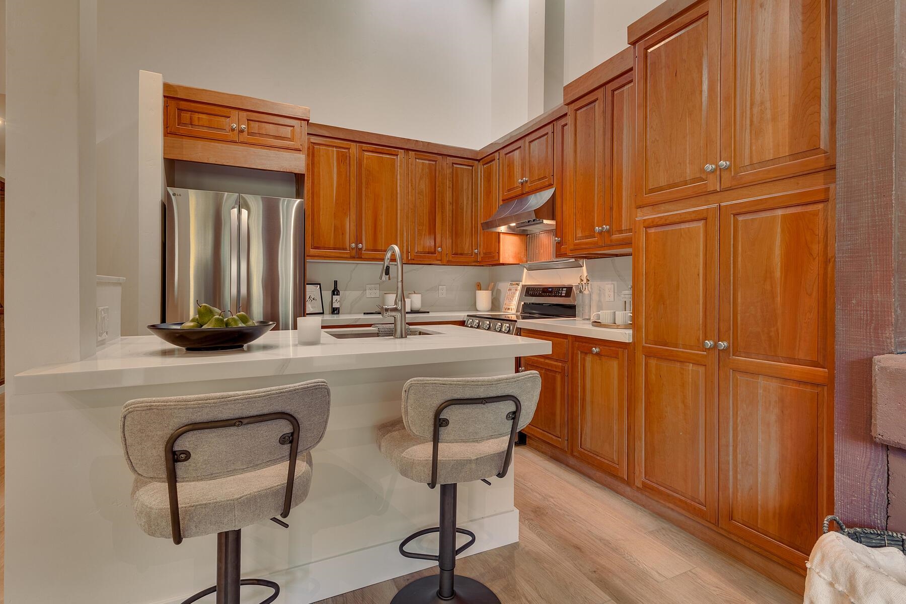 205 Alpine Meadows Road, Unit 2 Alpine Meadows, CA 96145 - Photo 10 of 28 a kitchen with a refrigerator a sink and cabinets
