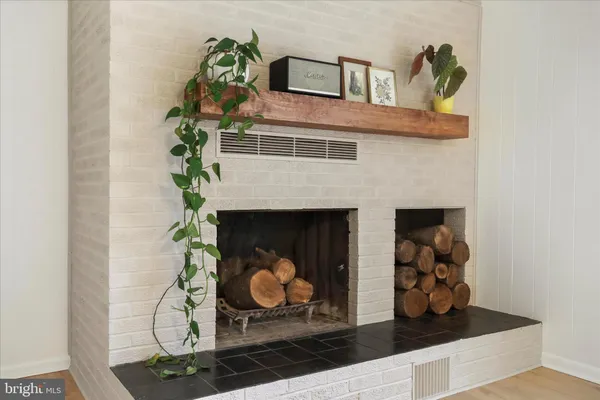 an empty room with windows and fireplace