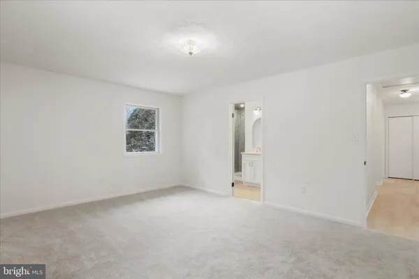 a bathroom with a double vanity sink toilet and a mirror