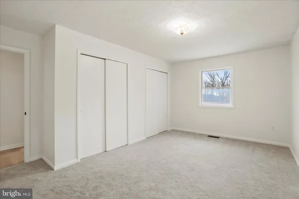 an empty room with windows and entrance