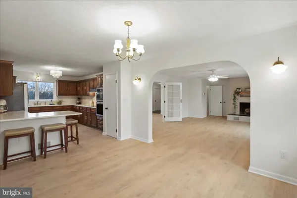 a view of a livingroom with a kitchen and chandelier