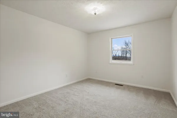 a kitchen with stainless steel appliances a table chairs refrigerator and a sink