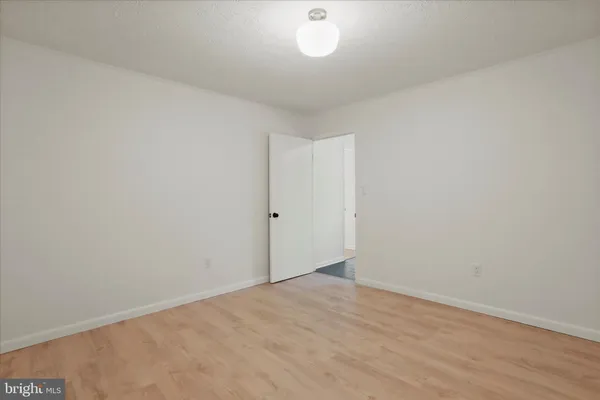 a kitchen with stainless steel appliances a table chairs refrigerator and a sink