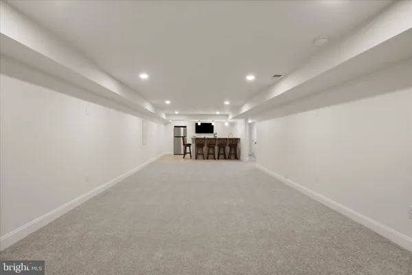 a view of a terrace with a bench and trees