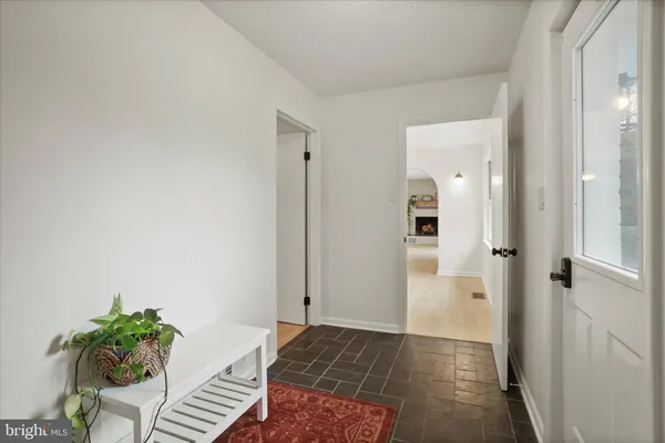 a kitchen with stainless steel appliances granite countertop a sink dishwasher stove and refrigerator with wooden cabinets