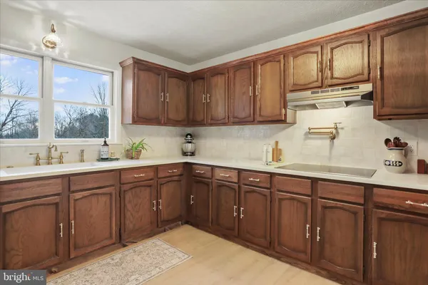 a kitchen with granite countertop wooden cabinets and white appliances