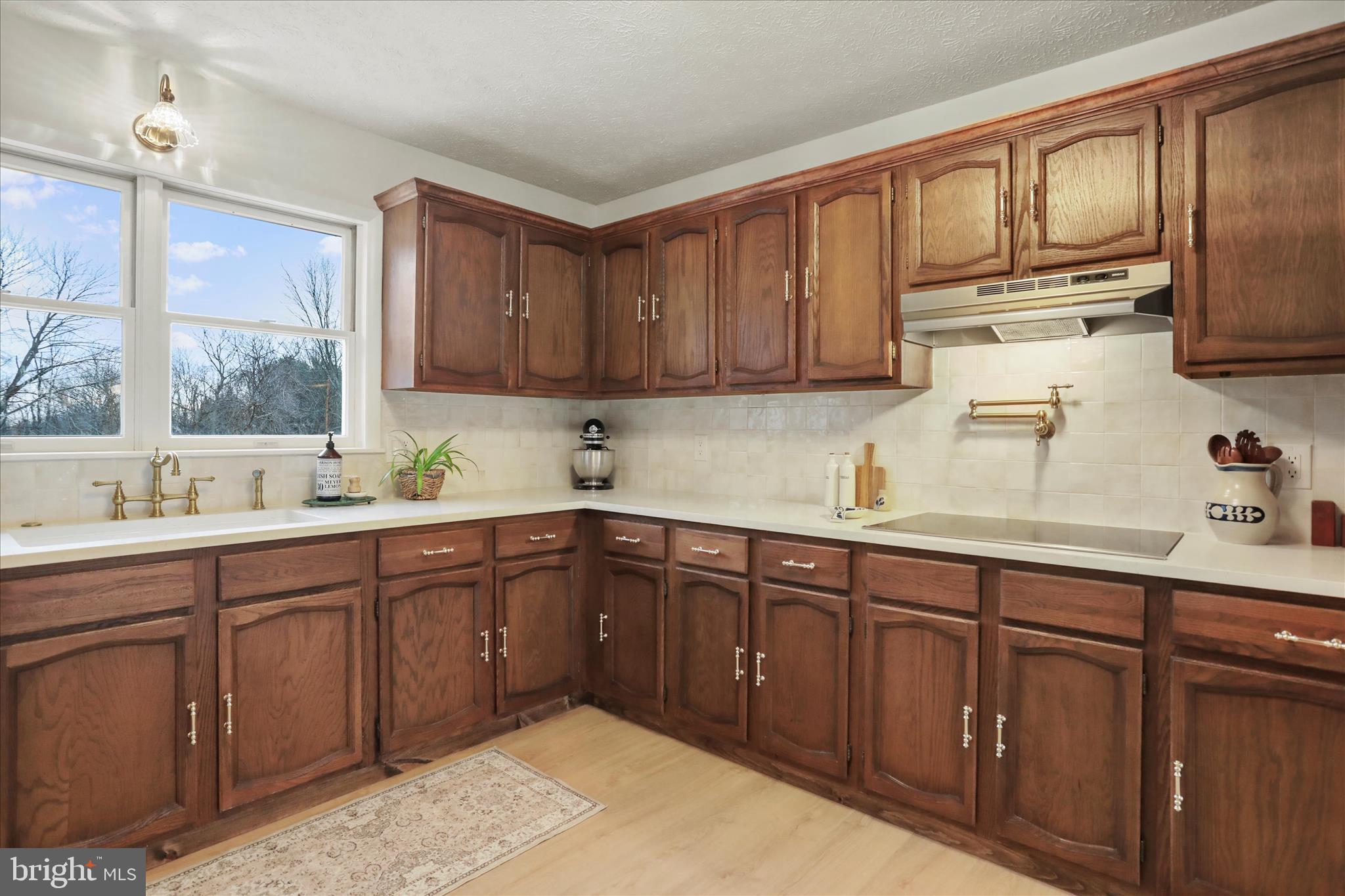 717 West Locust Street Woodstock, VA 22664 - Photo 9 of 71 a kitchen with stainless steel appliances granite countertop wooden cabinets a sink and dishwasher with wooden floor