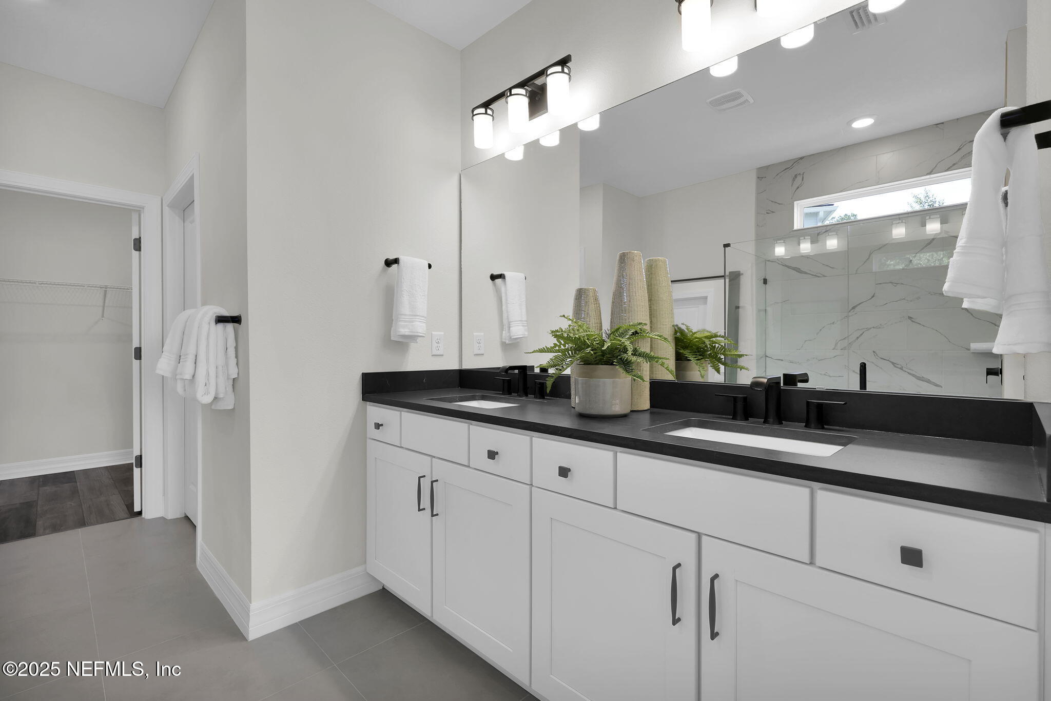 39 Blind Oak Circle St. Augustine, FL 32095 - Photo 12 of 26 a bathroom with double sink and a mirror