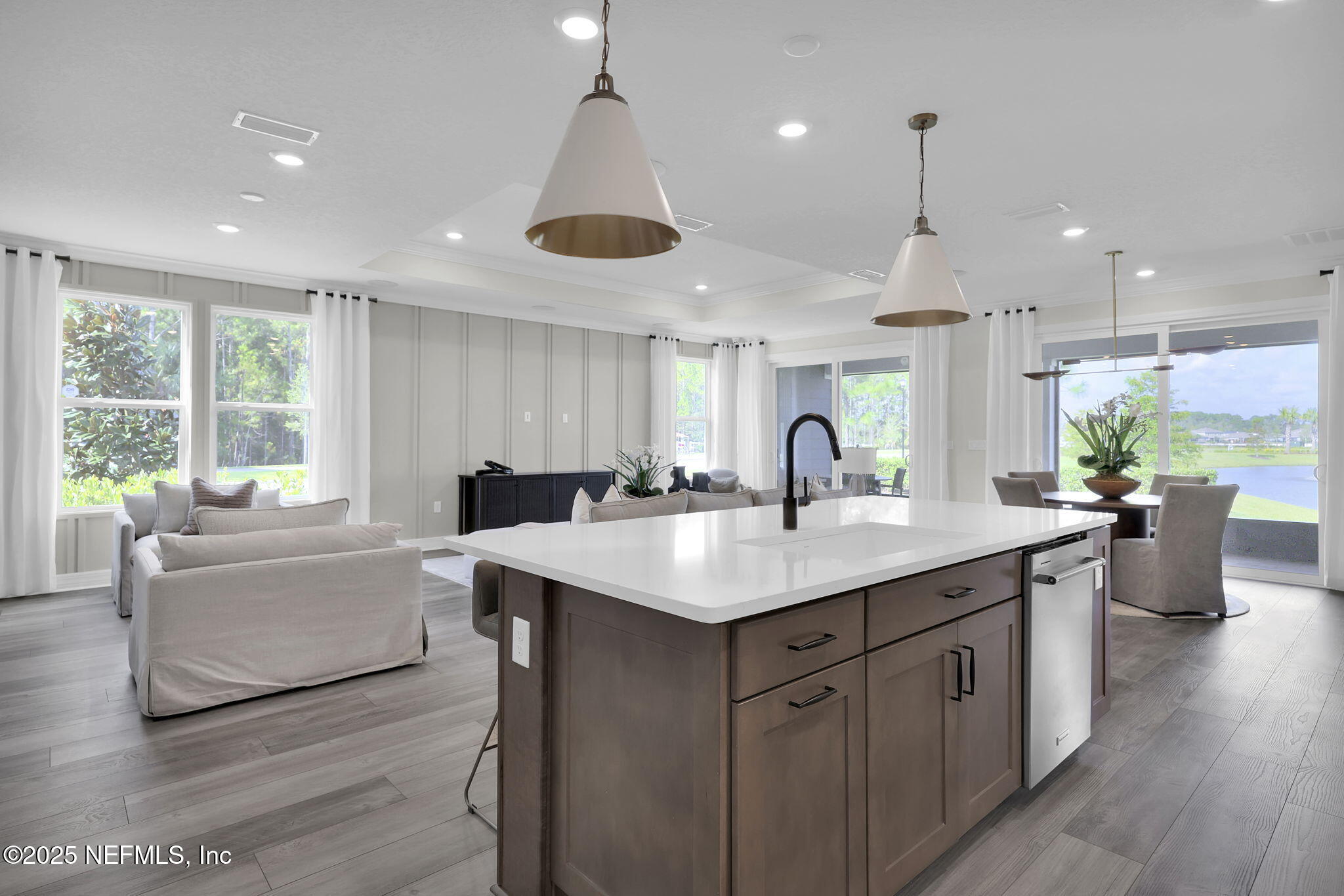 39 Blind Oak Circle St. Augustine, FL 32095 - Photo 6 of 26 a kitchen with counter top space sink and living room view