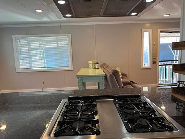 a kitchen with wooden cabinets and a stove top oven