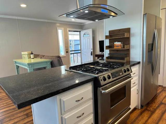 a kitchen with stainless steel appliances granite countertop a stove and a refrigerator