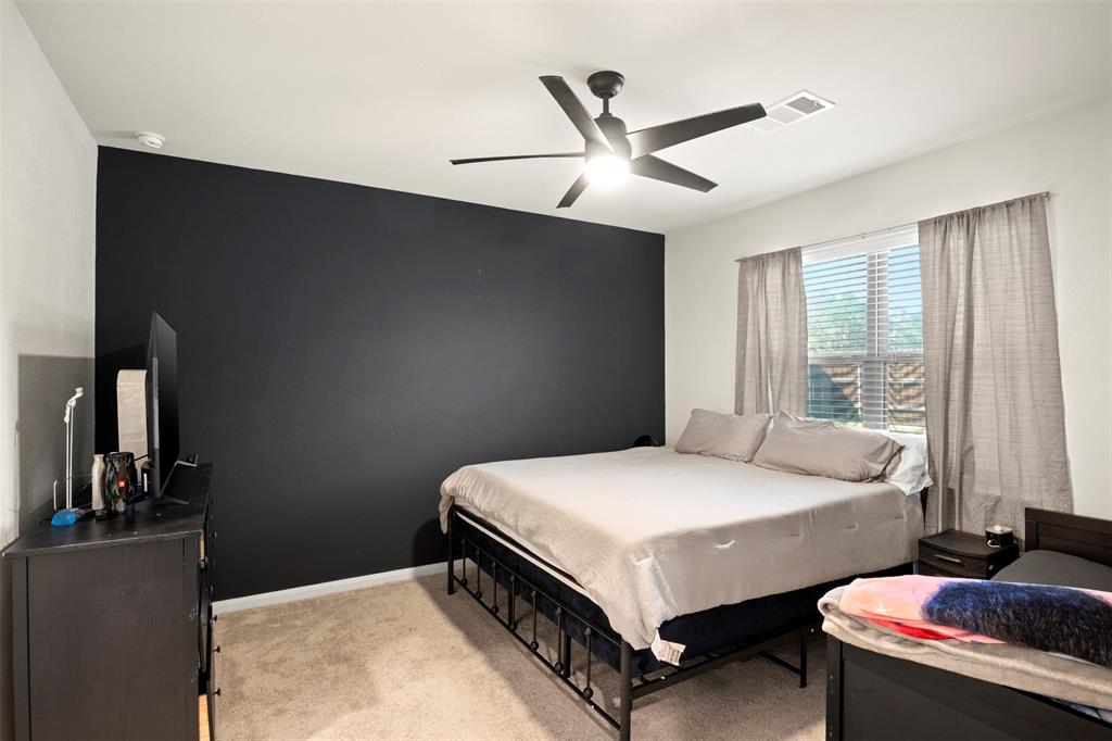 105 Patton Lane Venus, TX 76084 - Photo 14 of 29 Bedroom with light colored carpet and ceiling fan