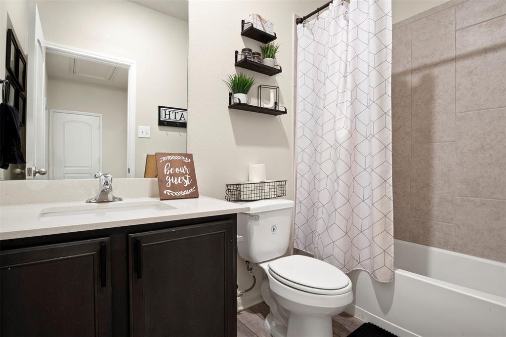 105 Patton Lane Venus, TX 76084 - Photo 20 of 29 Full bath featuring vanity, shower / bathtub combination with curtain, and light wood-style flooring