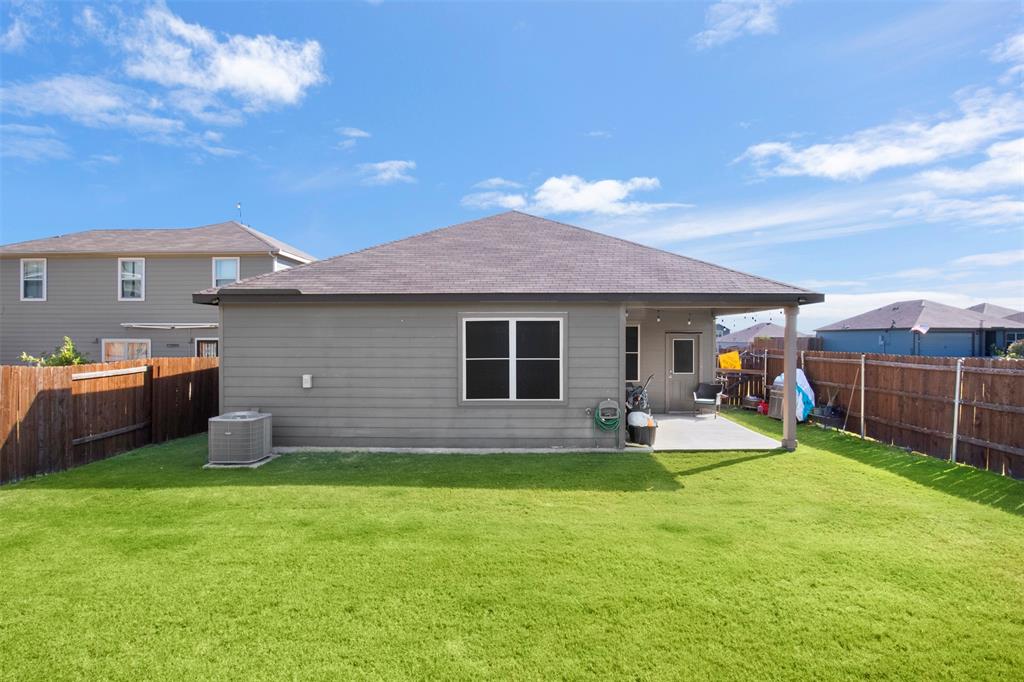 105 Patton Lane Venus, TX 76084 - Photo 23 of 29 Back of property with a patio, roof with shingles, and a fenced backyard