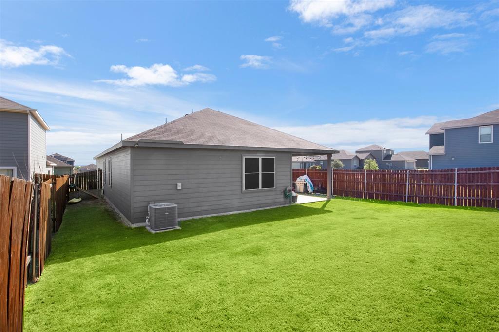 105 Patton Lane Venus, TX 76084 - Photo 24 of 29 Rear view of property featuring a shingled roof and a fenced backyard