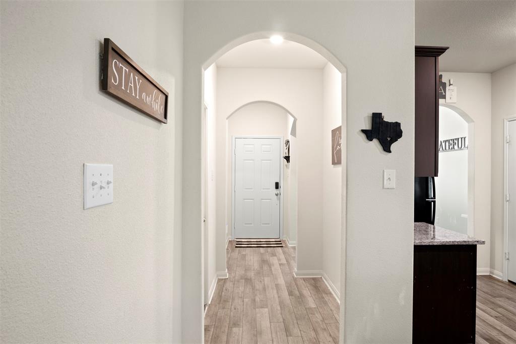 105 Patton Lane Venus, TX 76084 - Photo 4 of 29 Hallway featuring light wood finished floors and arched walkways