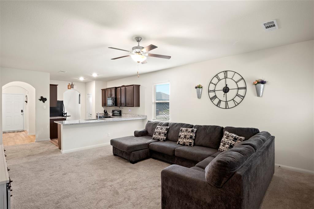 105 Patton Lane Venus, TX 76084 - Photo 5 of 29 Living room with arched walkways, light colored carpet, and a ceiling fan