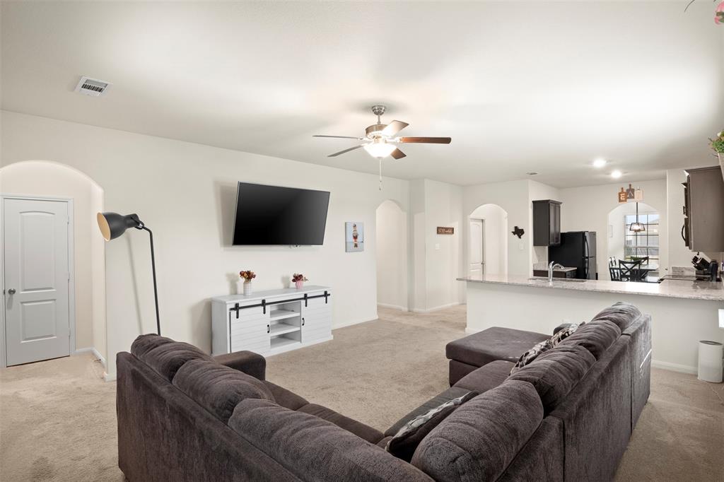 105 Patton Lane Venus, TX 76084 - Photo 6 of 29 Living room with light carpet, ceiling fan, and arched walkways
