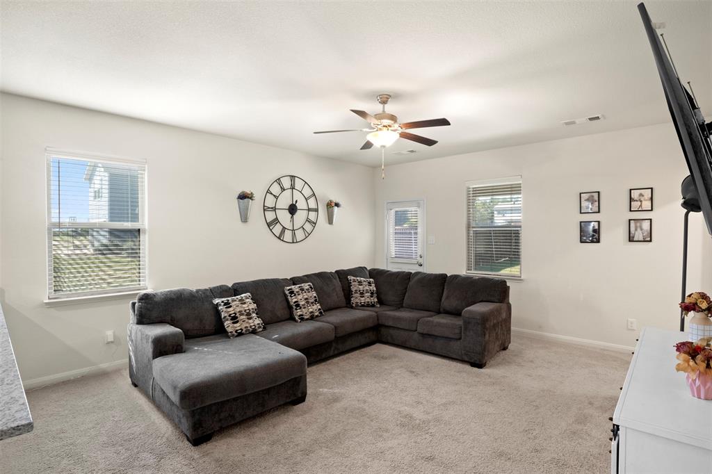 105 Patton Lane Venus, TX 76084 - Photo 7 of 29 Living area with light colored carpet and a ceiling fan