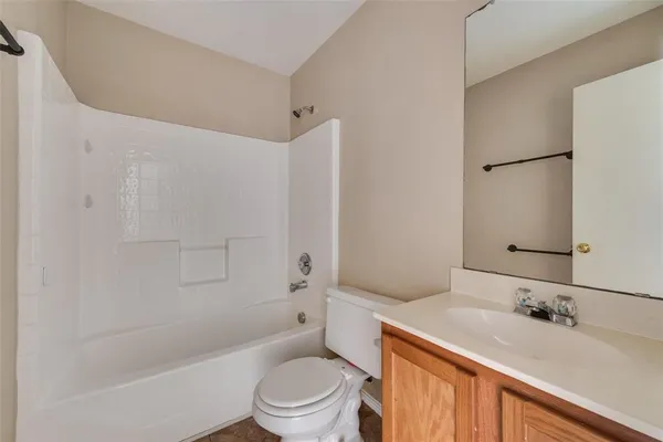 a bathroom with a granite countertop sink toilet tub and shower