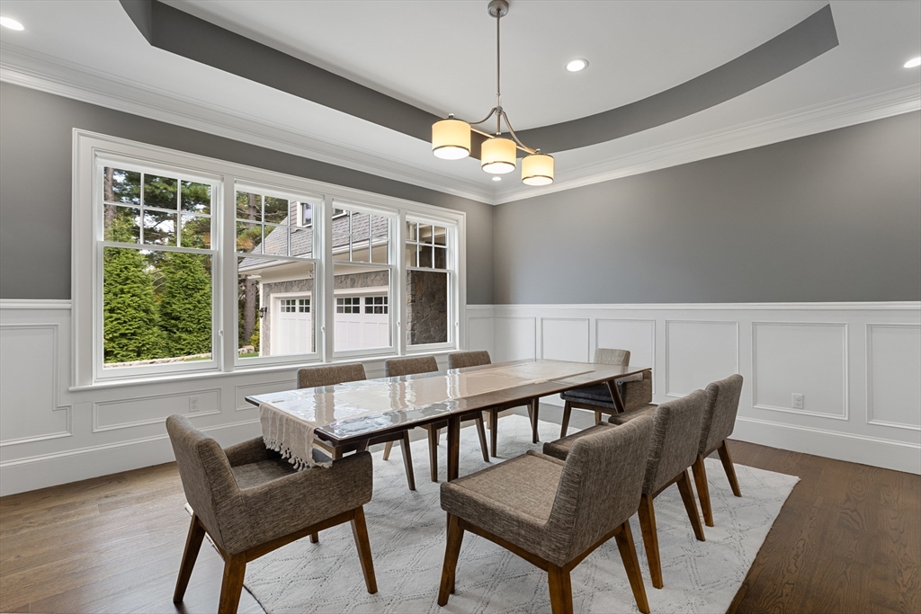 23 Crafts Road Brookline, MA 02467 - Photo 27 of 42 a view of a dining room with furniture wooden floor and chandelier