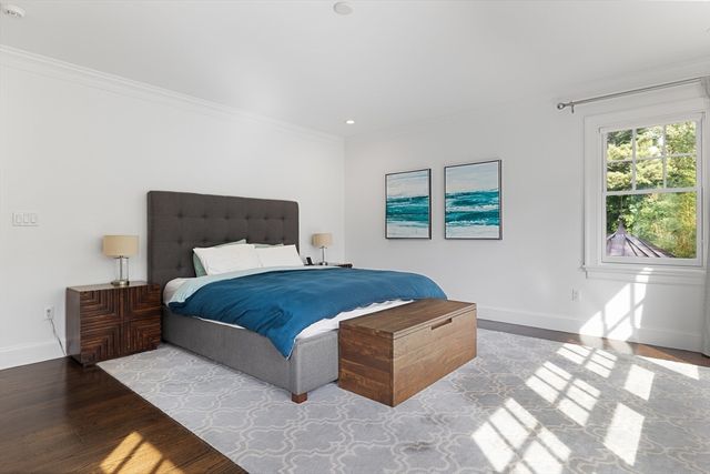 a bedroom with a large bed and a window