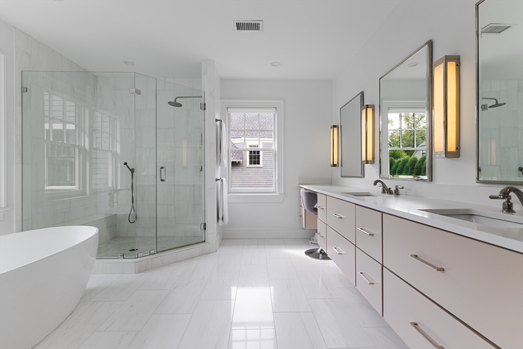 23 Crafts Road Brookline, MA 02467 - Photo 33 of 42 a spacious bathroom with a double vanity sink toilet mirror and bathtub