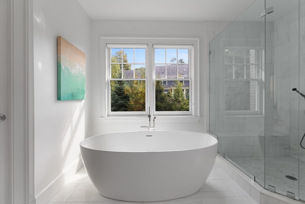 23 Crafts Road Brookline, MA 02467 - Photo 34 of 42 a white bath tub sitting in a bathroom next to a window