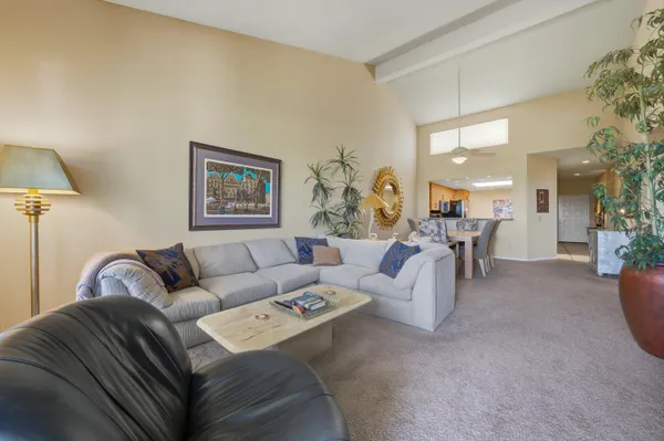 a living room with furniture and a lamp