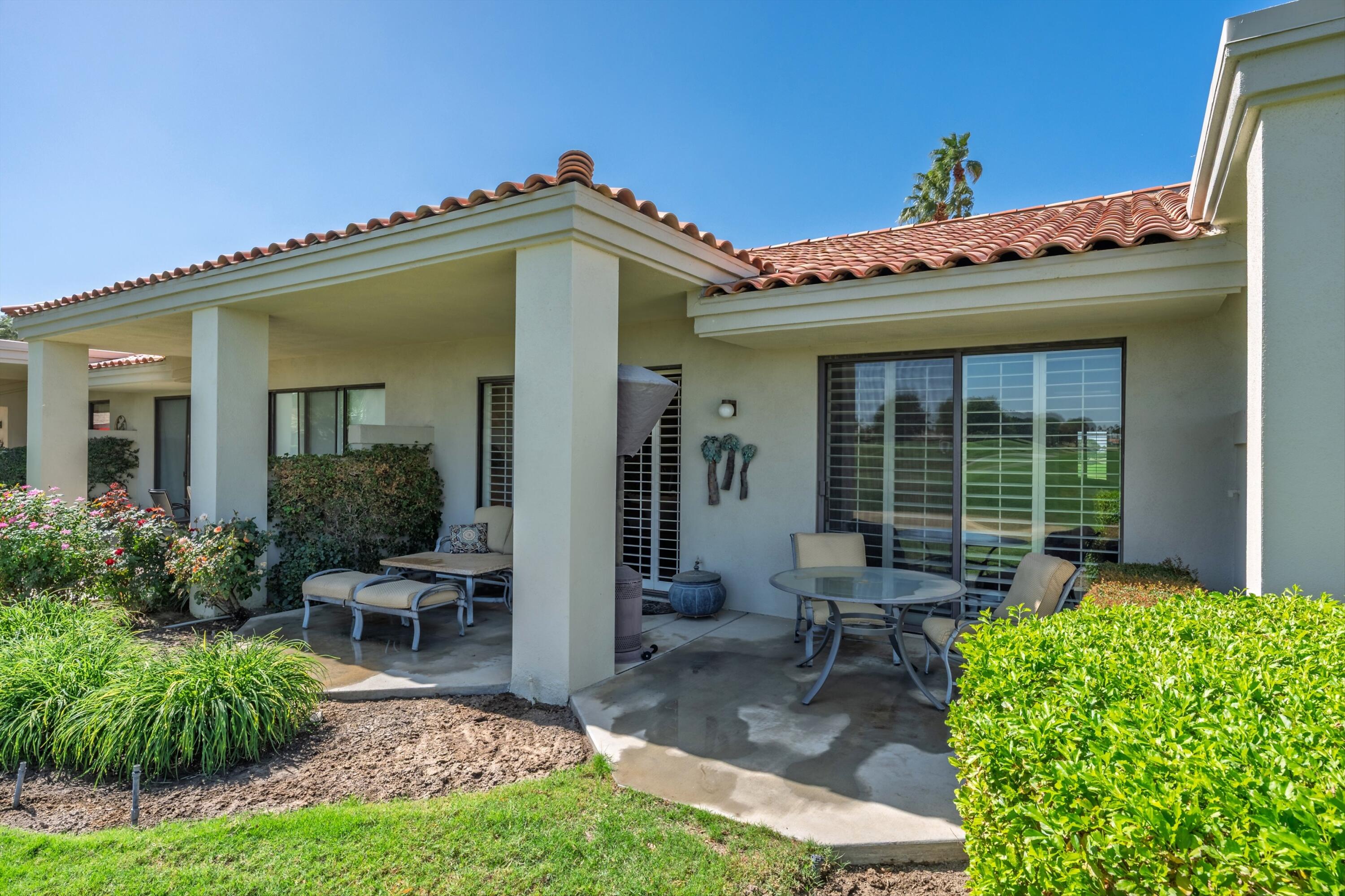 54860 Inverness Way La Quinta, CA 92253 - Photo 7 of 26 a view of a patio with table and chairs and potted plants