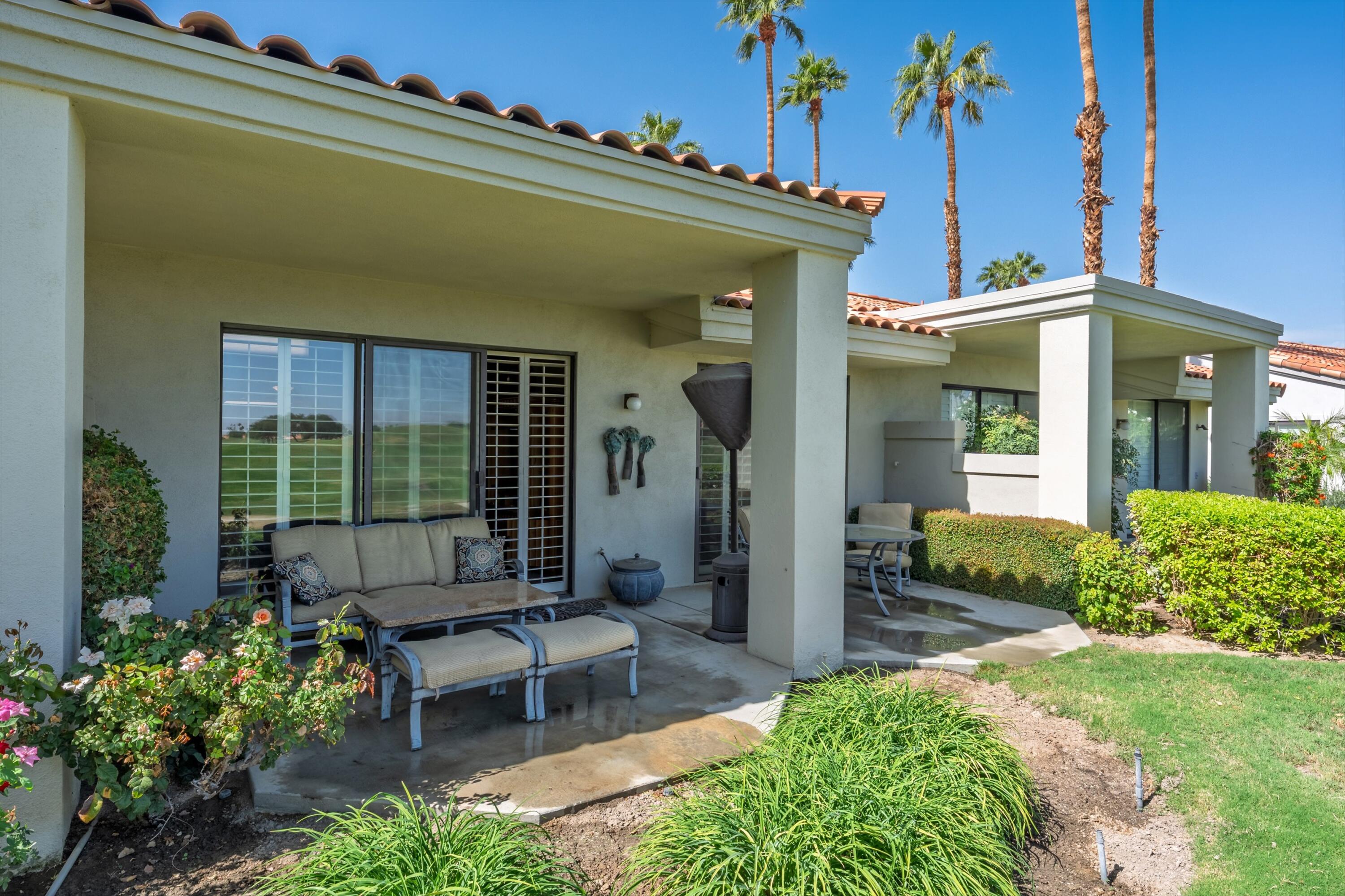 54860 Inverness Way La Quinta, CA 92253 - Photo 8 of 26 a view of a patio with table and chairs and potted plants