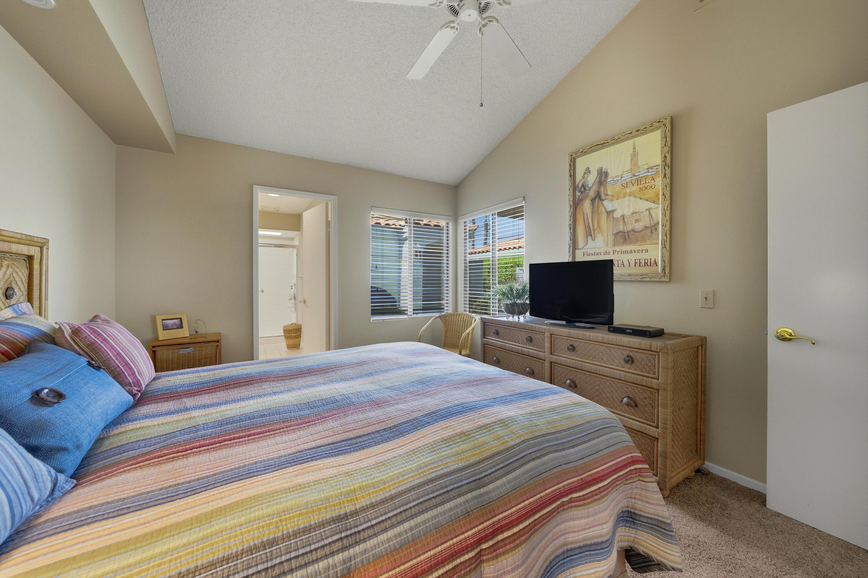 54860 Inverness Way La Quinta, CA 92253 - Photo 10 of 26 a bedroom with a bed and a flat screen tv