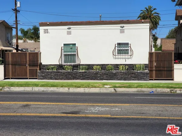 a view of a house with a street