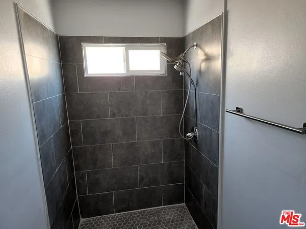 a bathroom with a glass door shower