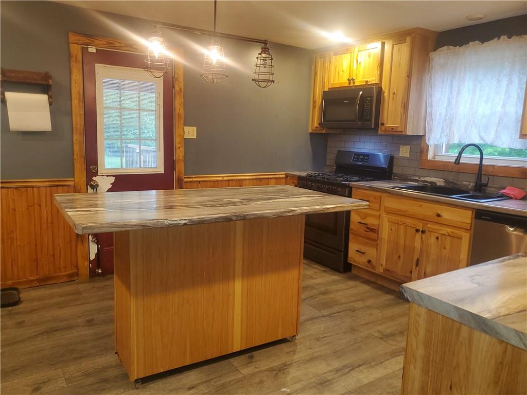132 Laird's Crossing Road Worthington, PA 16262 - Photo 8 of 20 a kitchen with a sink a stove cabinets and wooden floor