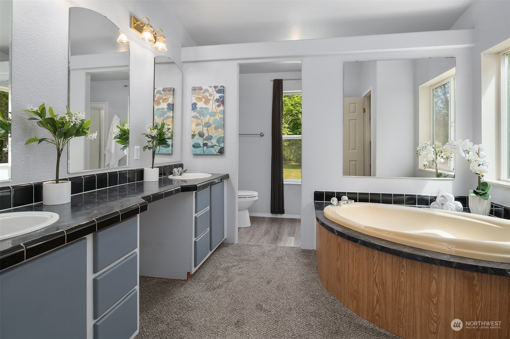28932 Northeast Big Rock Road Duvall, WA 98019 - Photo 16 of 27 a bathroom with a granite countertop sink a large mirror a bathtub and a window