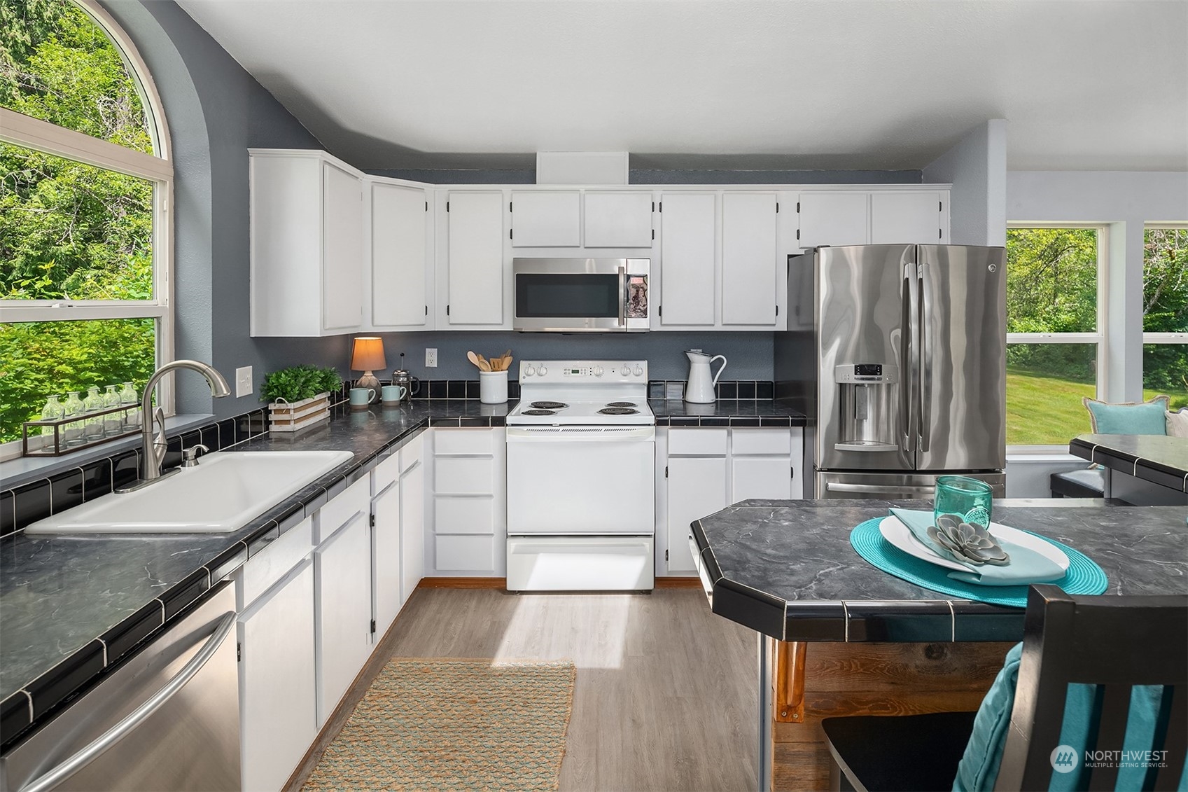 28932 Northeast Big Rock Road Duvall, WA 98019 - Photo 8 of 27 a kitchen with stainless steel appliances granite countertop a stove a sink a microwave a refrigerator and white cabinets