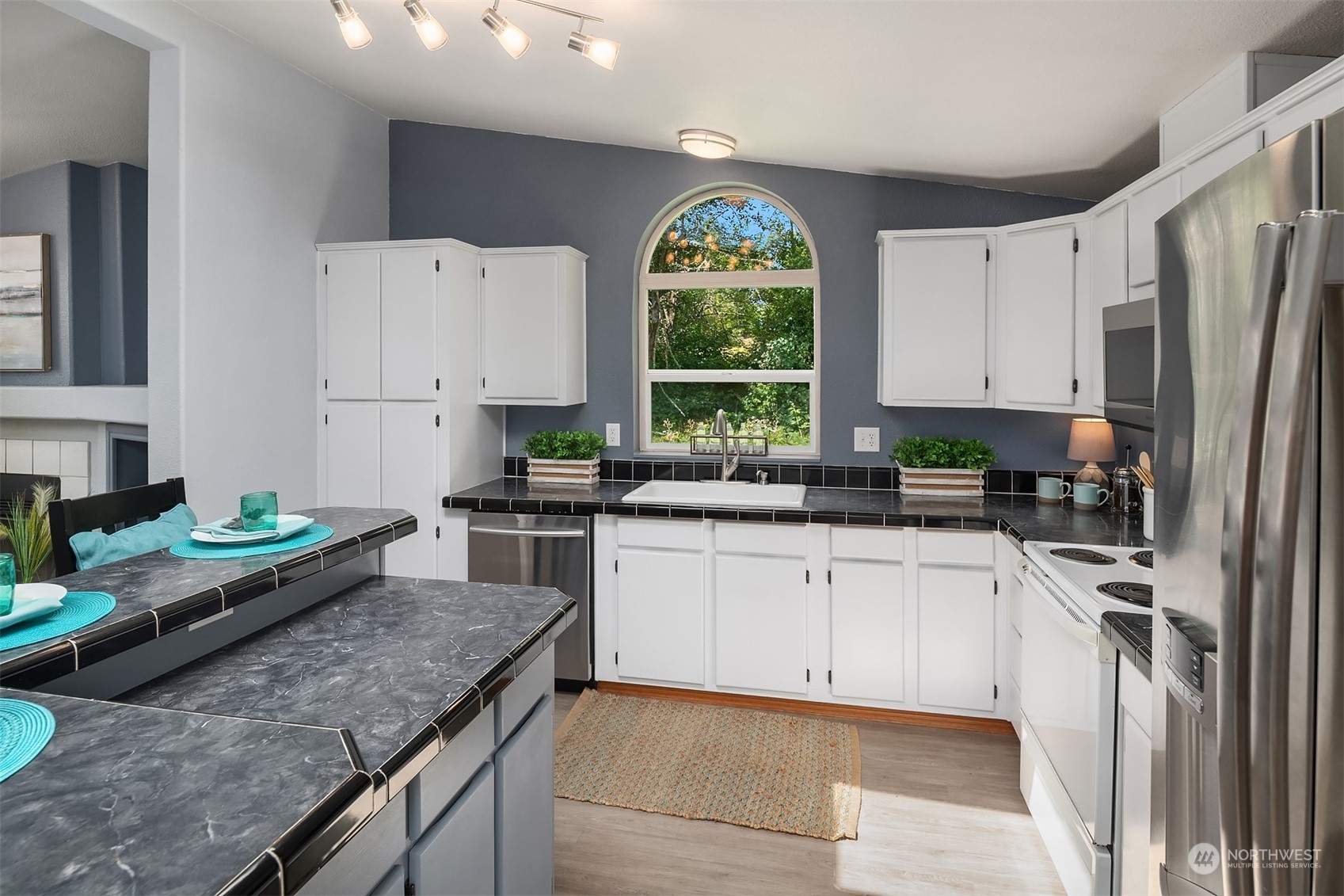 28932 Northeast Big Rock Road Duvall, WA 98019 - Photo 9 of 27 a kitchen with stainless steel appliances granite countertop a stove a sink a microwave a refrigerator and white cabinets