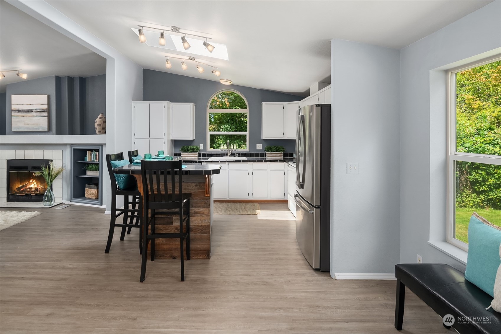 28932 Northeast Big Rock Road Duvall, WA 98019 - Photo 10 of 27 a kitchen with stainless steel appliances granite countertop a stove top oven a sink dishwasher a dining table and chairs with wooden floor