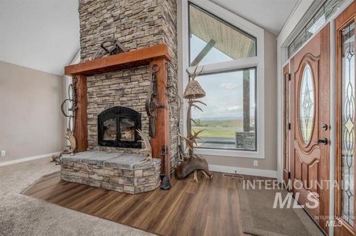 10228 Payette Heights Road Payette, ID 83661 - Photo 4 of 50 Stacked stone fireplace with a substantial timber mantelpiece and hearth
