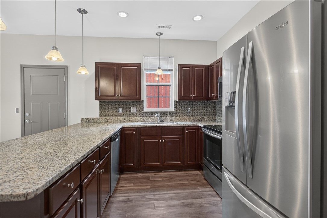 235 Pendleton Road, Unit K1 Clemson, SC 29631 - Photo 17 of 49 Modern kitchen with rich cabinetry, granite counters, and stainless steel appliances.