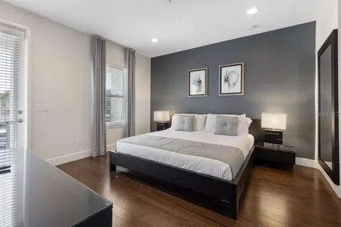 a bedroom with a bed and a night stand