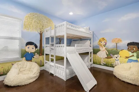 a living room with fireplace furniture and a wooden floor