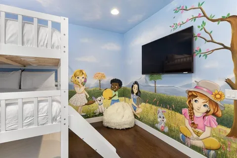 a living room with fireplace furniture and a flat screen tv