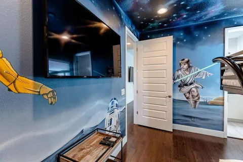 a view of a room with wooden floor